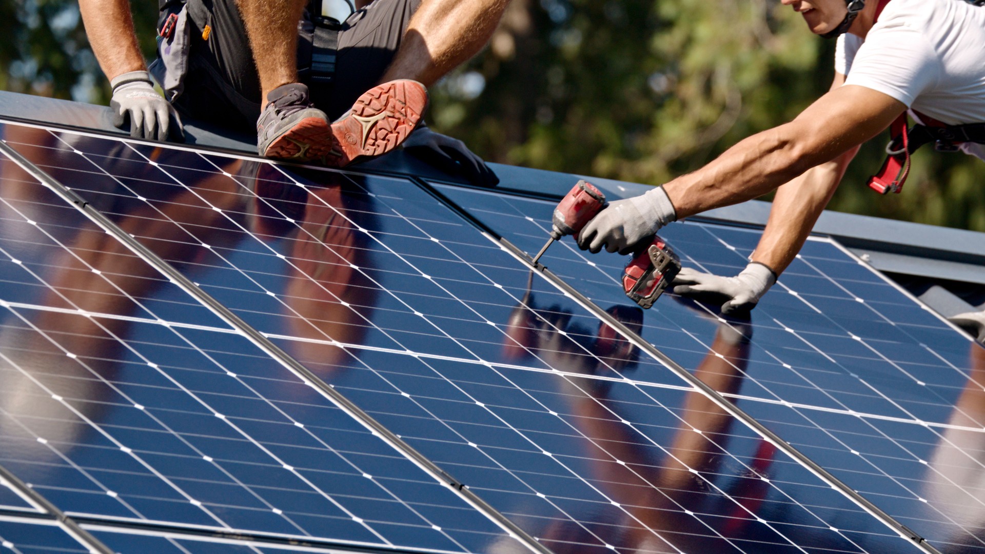 Solar Panel Installation by Technicians on Rooftop